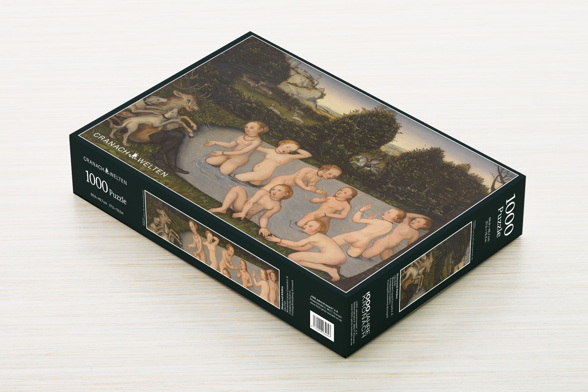 Puzzle-Schachtel „Diana und Aktäon“ schräg von oben auf heller Holzoberfläche, mit Deckelmotiv und Seitenaufdruck „CRANACH-WELTEN 1000 Puzzle“